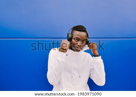 Similar – Young black man listening to music