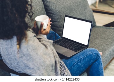 Young african american black woman relaxing and using laptop computer with white mockup blank screens.woman checking social apps and working.Communication and technology concept