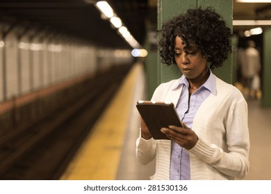 Young African American Black Woman Using Tablet Pc In Subway Station