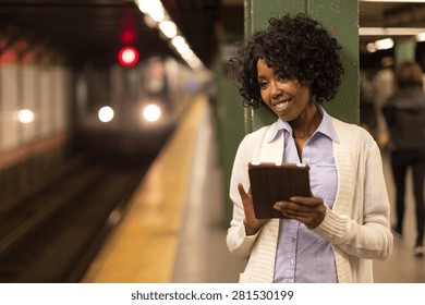 Young African American Black Woman Using Tablet Pc In Subway Station