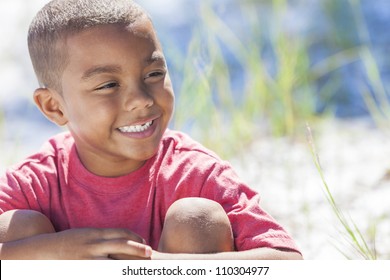 A Young African American Boy Child Outside In The Summer Sunshine