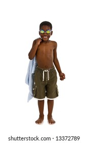 A Young African American Boy Wearing Swim Trunks And Goggles, And Carrying A Towel. Isolated On A White Background.