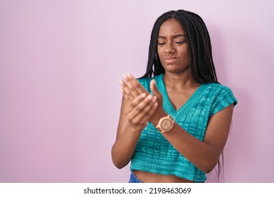 Young African American With Braids Standing Over Pink Background Suffering Pain On Hands And Fingers, Arthritis Inflammation 