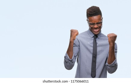 Young African American Business Man Over Isolated Background Very Happy And Excited Doing Winner Gesture With Arms Raised, Smiling And Screaming For Success. Celebration Concept.