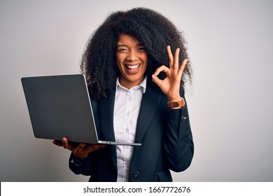 Young African American Business Woman With Afro Hair Using Computer Laptop From Job Doing Ok Sign With Fingers, Excellent Symbol