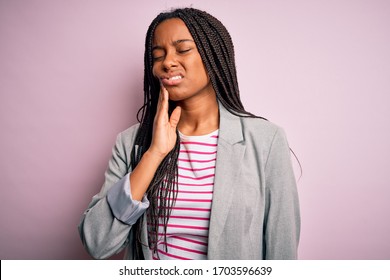 Young African American Business Woman Standing Over Pink Isolated Background Touching Mouth With Hand With Painful Expression Because Of Toothache Or Dental Illness On Teeth. Dentist