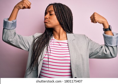 Young African American Business Woman Standing Over Pink Isolated Background Showing Arms Muscles Smiling Proud. Fitness Concept.