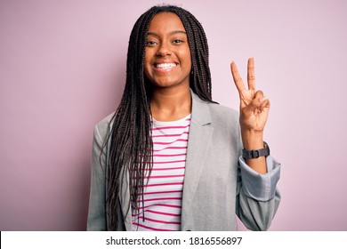 Young African American Business Woman Standing Over Pink Isolated Background Showing And Pointing Up With Fingers Number Two While Smiling Confident And Happy.