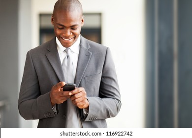 Young African American Businessman Reading Email On Smart Phone