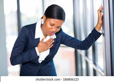 Young African American Businesswoman Having Heart Attack Or Chest Pain