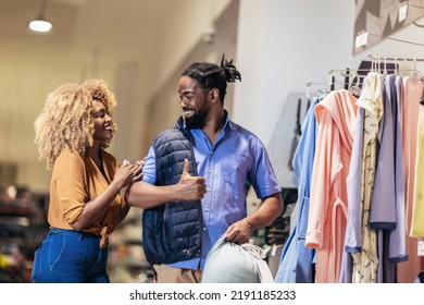 Young African American Couple Buying Clothes 