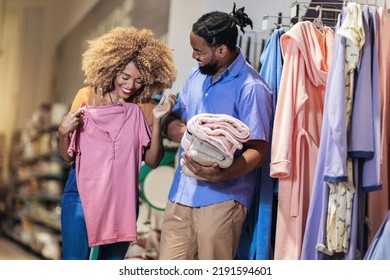 Young African American Couple Buying Clothes 