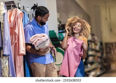 Young African American Couple Buying Clothes 