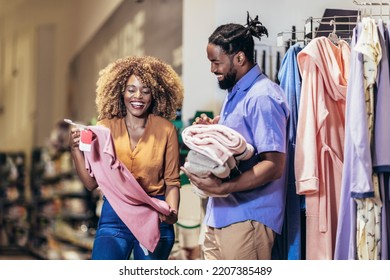 Young African American Couple Buying Clothes 