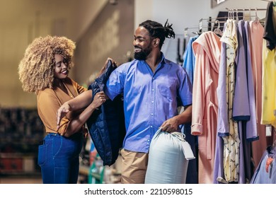 Young African American Couple Buying Clothes 