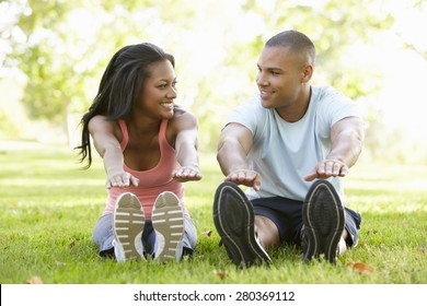 Young African American Couple Exercising In Park