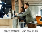 A young African American couple happily checking into their hotel, excited for their upcoming vacation.