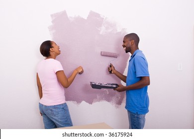 Young African American Couple Painting House