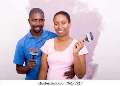 Young African American Couple Painting House