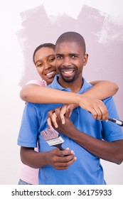 Young African American Couple Painting House