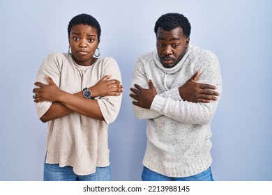 Young African American Couple Standing Over Blue Background Together Shaking And Freezing For Winter Cold With Sad And Shock Expression On Face 