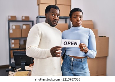 Young African American Couple Working At Small Business Ecommerce Clueless And Confused Expression. Doubt Concept. 