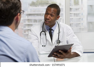 Young African American Doctor Consulting With Patient, Horizontal