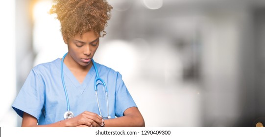 Young African American Doctor Woman Over Isolated Background Checking The Time On Wrist Watch, Relaxed And Confident