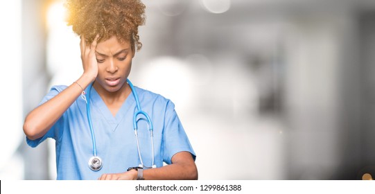 Young African American Doctor Woman Over Isolated Background Looking At The Watch Time Worried, Afraid Of Getting Late