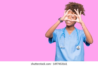Young African American Doctor Woman Over Isolated Background Doing Heart Shape With Hand And Fingers Smiling Looking Through Sign