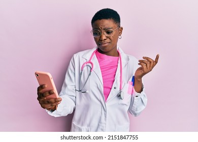 Young african american doctor woman doing video call using smartphone skeptic and nervous, frowning upset because of problem. negative person.  - Powered by Shutterstock