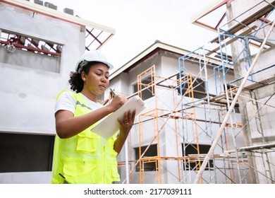 Young African American Engineer And Architect Working At Construction Site With Calculate Spending Report Inside House. Real Estate Project With Civil Engineer. Power Line Inspection