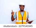 young African American engineer wearing a white hard hat holding paper work while pointing up for recommendation