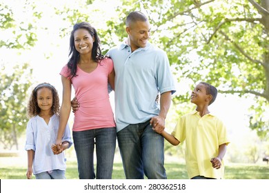 Young African American Family Enjoying Walk In Park