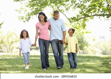 Young African American Family Enjoying Walk In Park