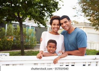 Young African American family outside their new house