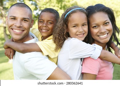 Young African American Family Relaxing In Park