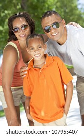 A Young African American Family, Woman, Man, Father, Mother & Boy Child Outside In The Summer