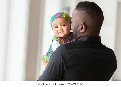 Young African American Father Holding With Her Baby Girl