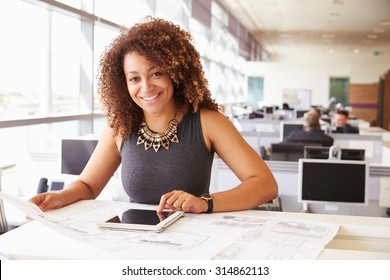 Young African American female architect working in an office