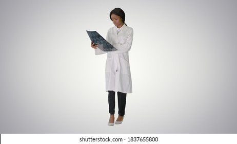 Young African American Female Doctor Looking At Xray While Walki