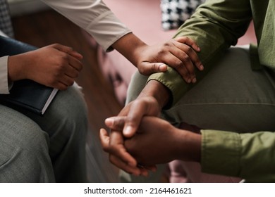 Young African American Female Psychologist Keeping Hand Of Wrist Of Male Patient Sitting In Front Of Her And Sharing His Problems