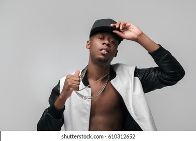 Young African American Gangster Man Portrait On Grey Background With Free Space. Neglecting, Arrogance, Swagger, Self-assumption. Ghetto, Challenge To Society, Cheeky, Cool, Rebellious