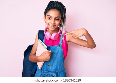 Young African American Girl Child With Braids Holding Student Backpack And Books Pointing Finger To One Self Smiling Happy And Proud 