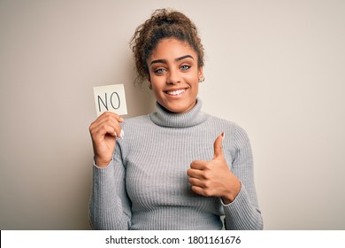 Young African American Girl Holding Reminder Paper With No Word Negative Message Happy With Big Smile Doing Ok Sign, Thumb Up With Fingers, Excellent Sign