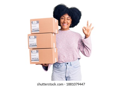 Young African American Girl Holding Delivery Package Doing Ok Sign With Fingers, Smiling Friendly Gesturing Excellent Symbol 