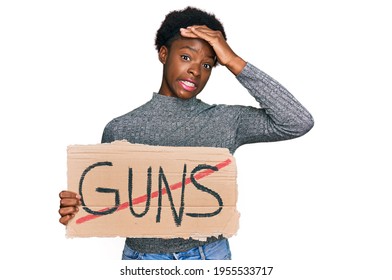 Young African American Girl Holding No Guns Warning Banner Stressed And Frustrated With Hand On Head, Surprised And Angry Face 