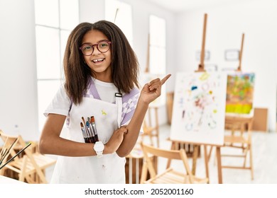 Young African American Girl Painting At Art Studio Smiling Happy Pointing With Hand And Finger To The Side 