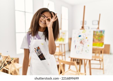 Young African American Girl Painting At Art Studio Smiling Happy Doing Ok Sign With Hand On Eye Looking Through Fingers 