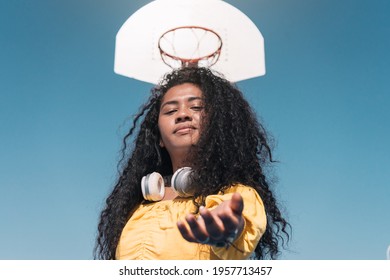 Young African American Girl Shaking Hands With Spectator At The Basketball Hoop.